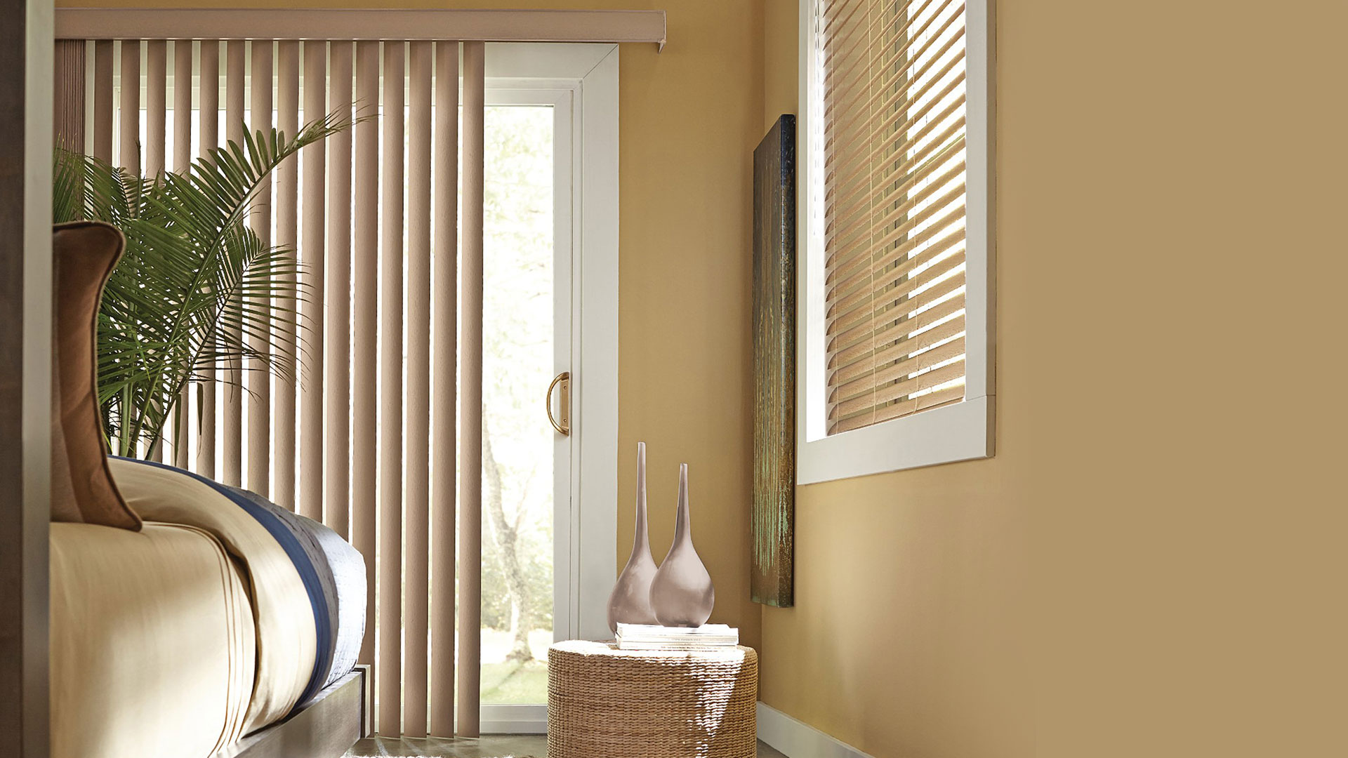 Vertical shades on a sliding patio door beside a bedroom window