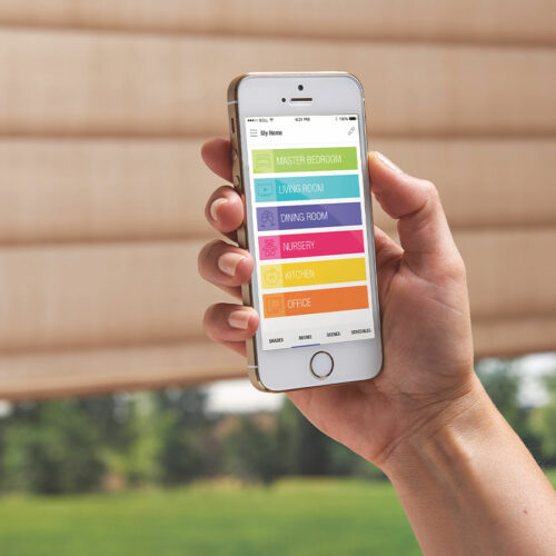 Hand adjusting a wall-mounted remote control for automated window coverings