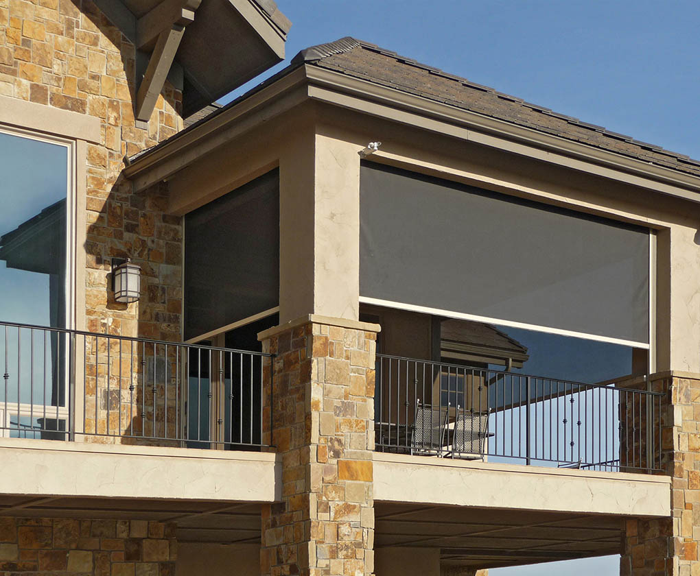 Exterior screen lowered on a stone balcony to block sun and wind