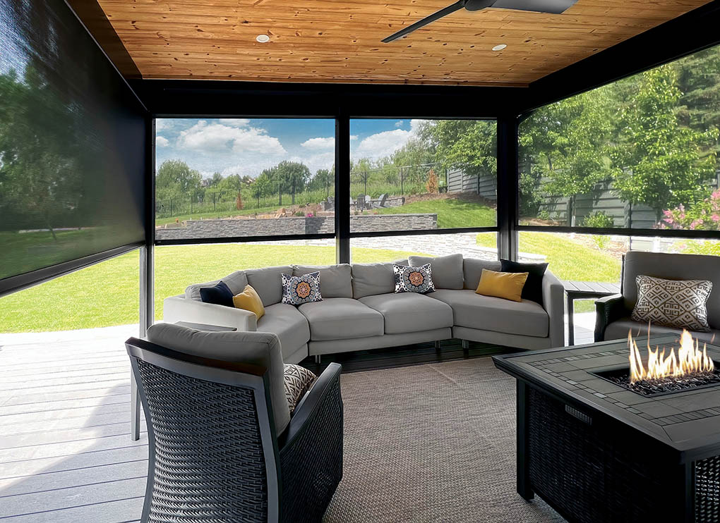 Outdoor patio with sleek black exterior screens surrounding a cozy sectional sofa and fire pit