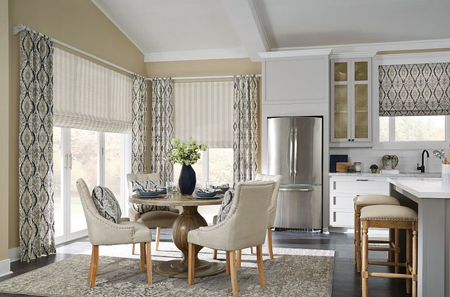 Dining and kitchen space featuring coordinated blinds and drapes, highlighting how upgraded window treatments enhance home value.
