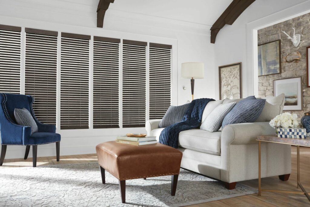 Modern living room with wood blinds, showcasing how stylish window treatments can increase a home’s value and appeal.