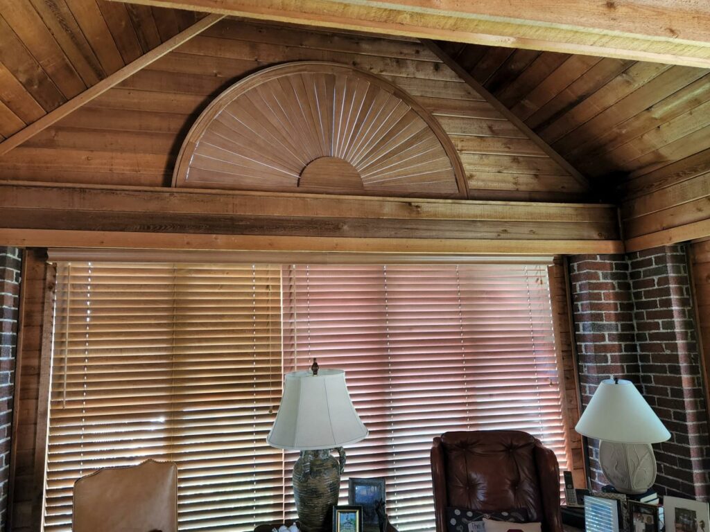 Home office featuring window blinds and wood ceiling design.