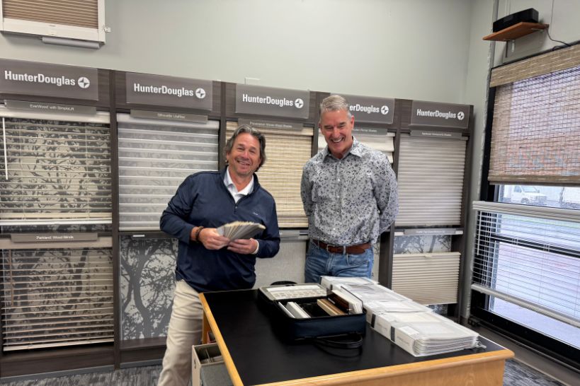 Two customers smiling while exploring different types of window shades at The Blind Factory Ohio showroom